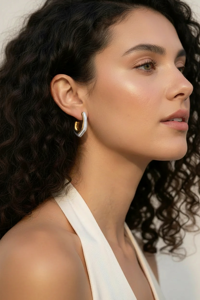 Curly hair model with pearl & gold hoop earring
