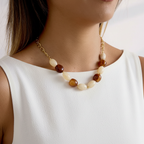 Model in white dress wearing beaded necklace