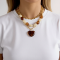 Model in white t-shirt with layered necklaces no hands