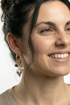 Model wearing charm earrings - refined